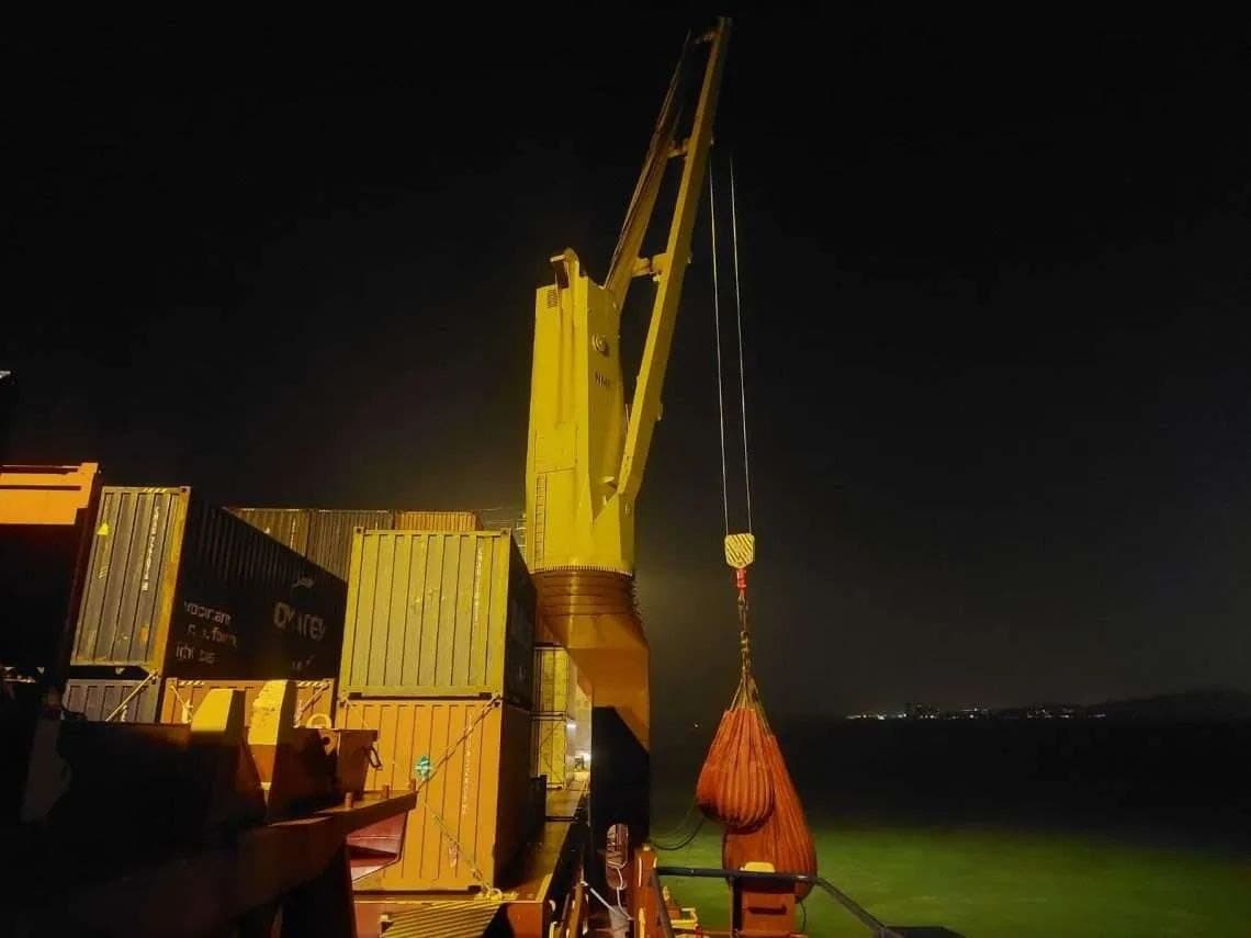 Deck crane working alongside at night