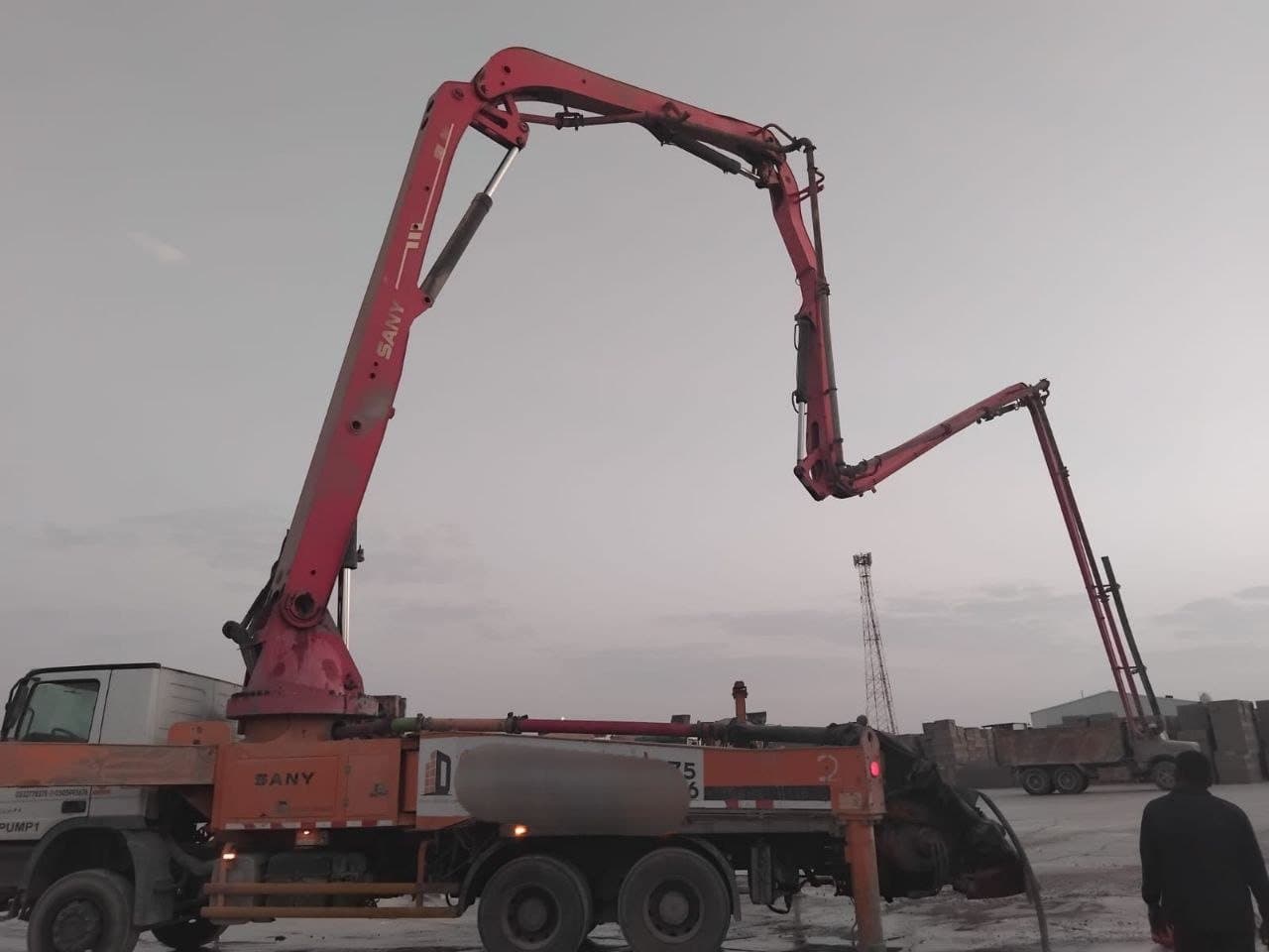 Truck-mounted concrete pump set up on site
